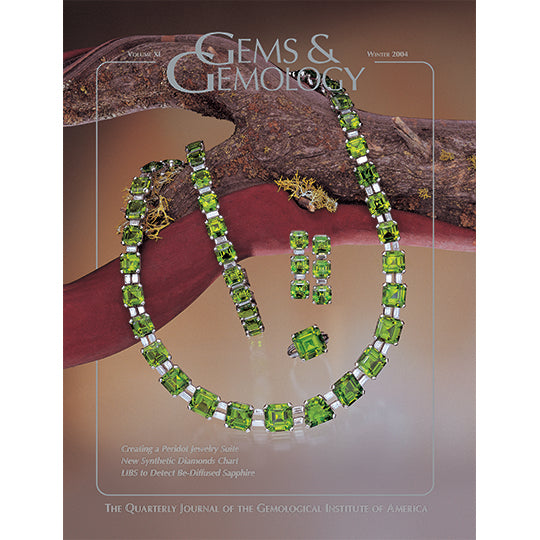 Cover of Gems & Gemology Winter 2004 issue, featuring bright green jewelry around tree branch