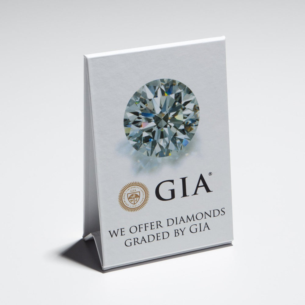 Stand-up white cardboard display with diamond, logo, and text "We Offer Diamonds Graded by GIA"