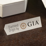 White triangular prism plate with text "Diamond Origin by GIA"