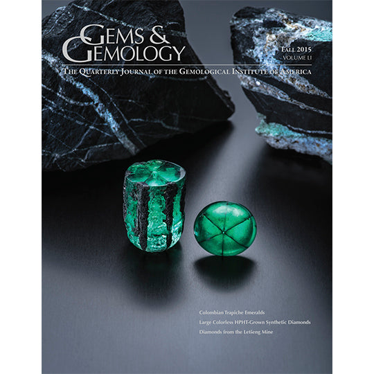 Cover of Gems & Gemology Fall 2015 issue, featuring rough green and black stones