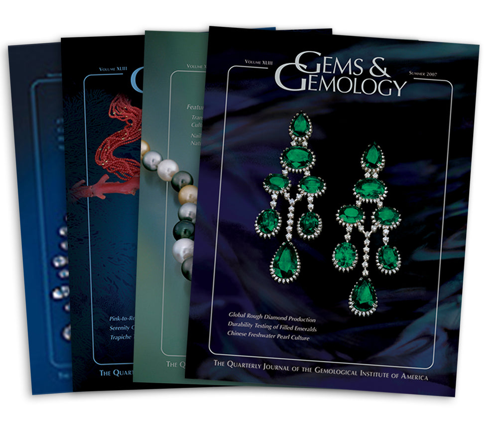 Stack of 4 2007 Gems & Gemology issues; top issue features earrings with 7 emeralds