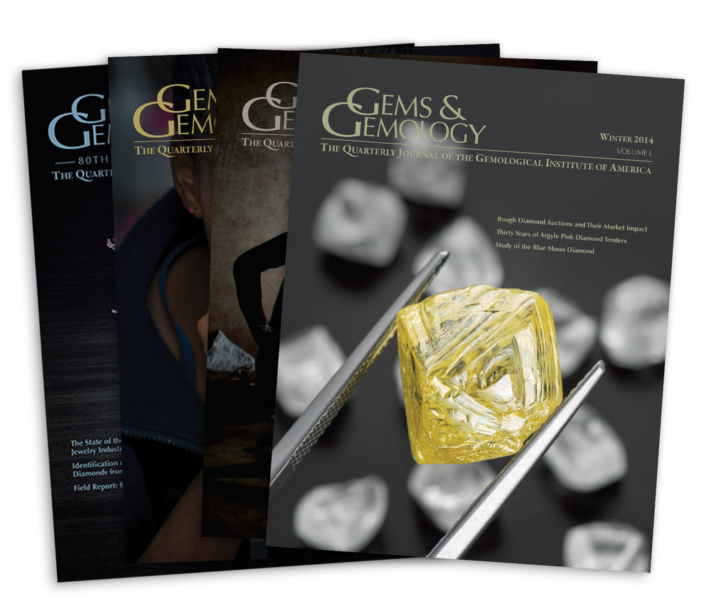 Stack of 4 2014 Gems & Gemology issues; top issue features yellow gemstone in between tweezers