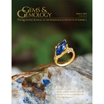 Cover of Gems & Gemology Spring 2015 issue, featuring ring with blue gem, sitting on blue-flecked stone