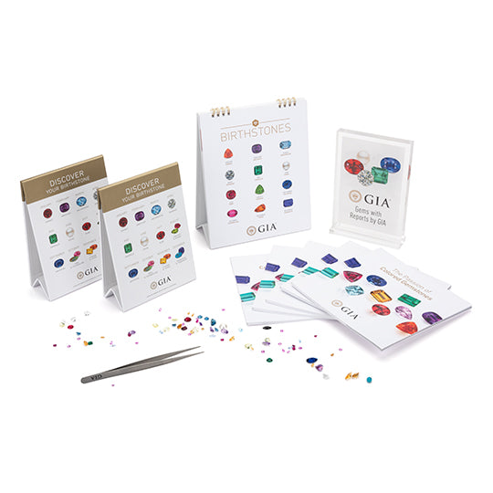 Displays and books included in GIA Colored Stones kit, displayed with gemstones and tweezer